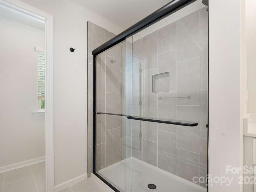 2023 Sadler Woods Lane, Charlotte, NC 28214.  MLS# CAR4263129, YatesRealty ID 14781. Tiled shower & floor. Representational Photo.