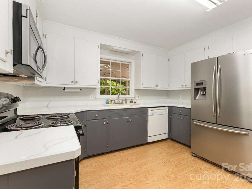 507 Richards Drive, Shelby, NC 28150.  MLS# CAR4256868, YatesRealty ID 14790. Kitchen with painted cabinests and stainless refrigerator