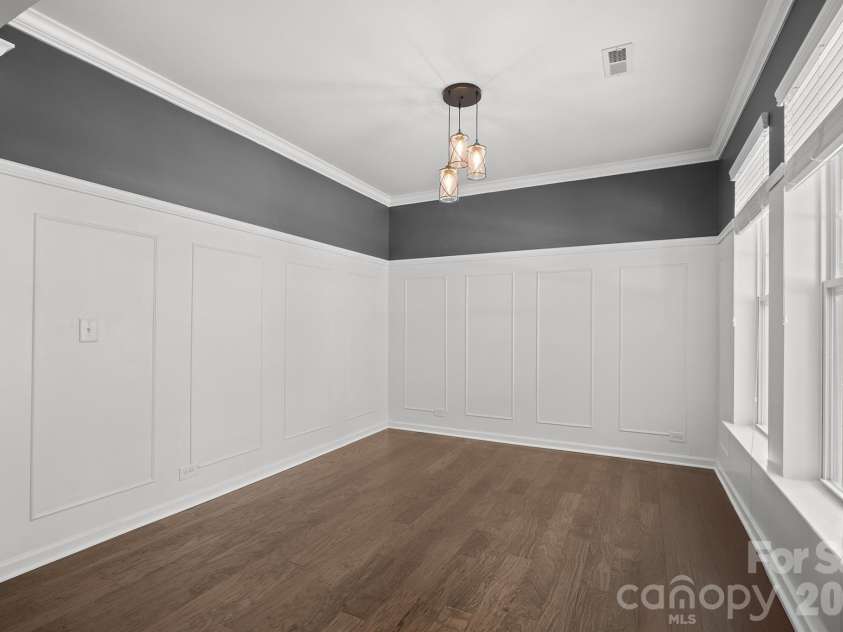 8920 Lake Pines Drive, Cornelius, NC 28031.  MLS# CAR4369266, YatesRealty ID 14825. Dining Room with elevated wainscoting and trim work.