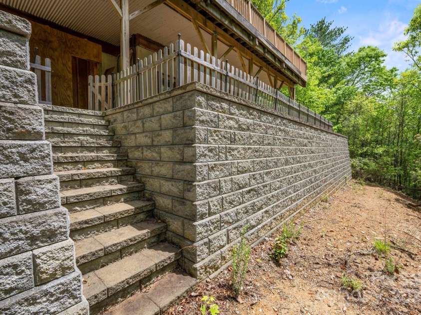 132 Vacation Way, Millers Creek, NC 28651.  MLS# CAR4254466, YatesRealty ID 14827. $60K improvement....beautiful stone retaining wall off rear covered terrace