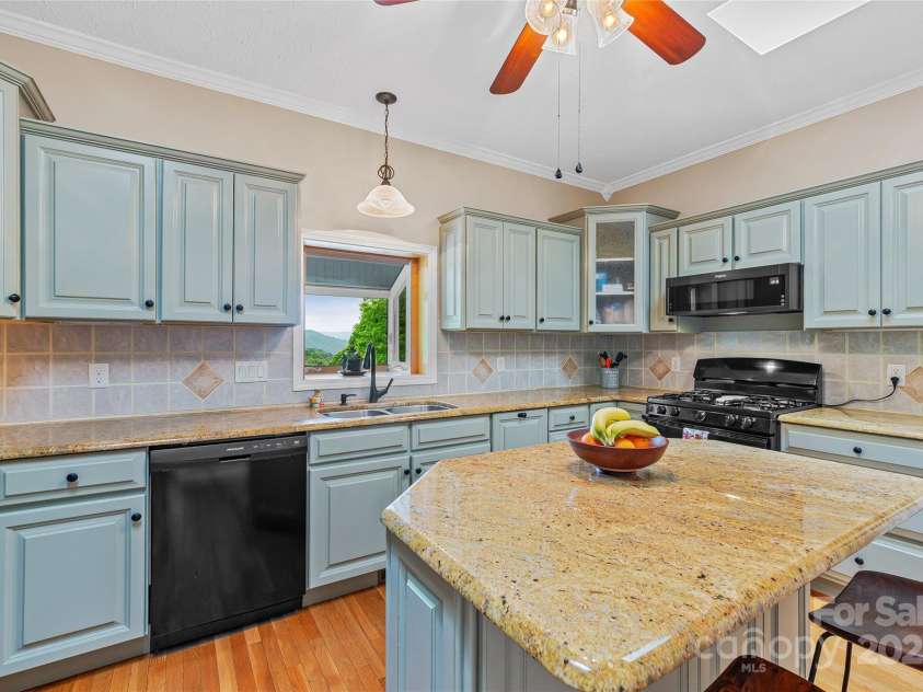 283 Grapevine Cove, Waynesville, NC 28785.  MLS# CAR4260835, YatesRealty ID 14836. Custom cabinetry and large prep island in kitchen
