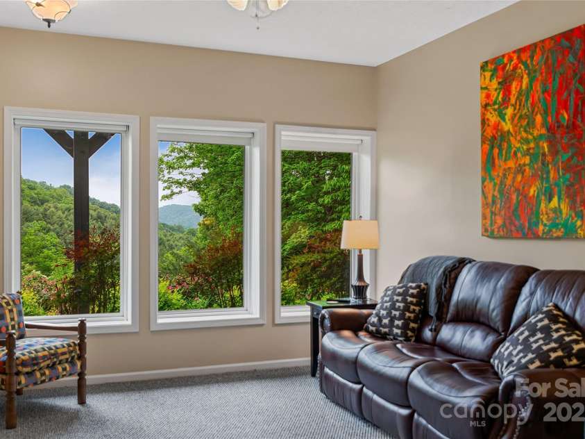 283 Grapevine Cove, Waynesville, NC 28785.  MLS# CAR4260835, YatesRealty ID 14836. Downstairs living room with garden views- so peaceful!