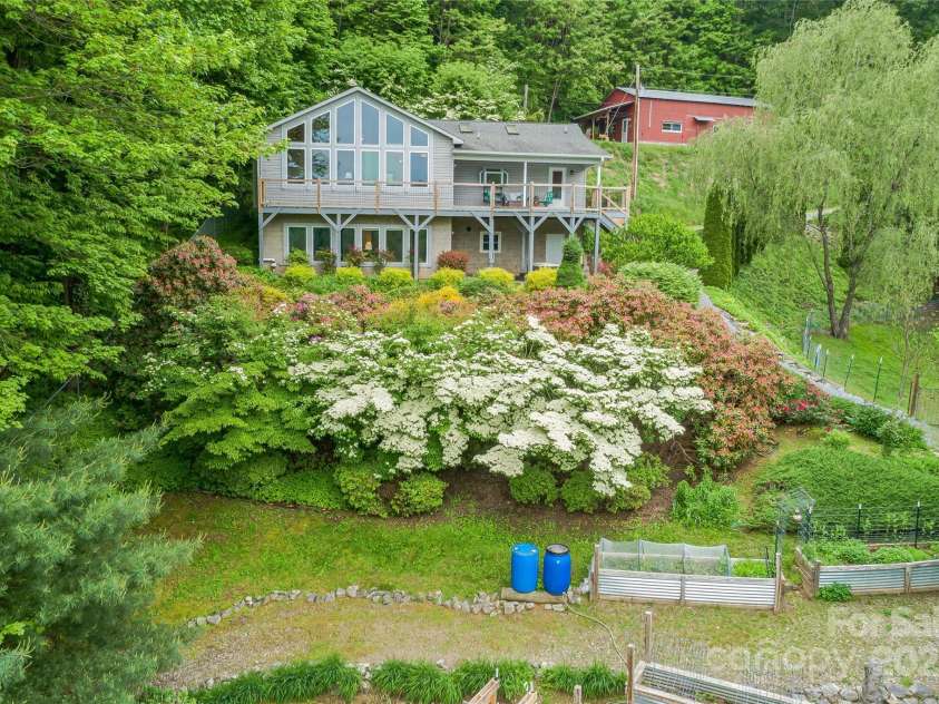 283 Grapevine Cove, Waynesville, NC 28785.  MLS# CAR4260835, YatesRealty ID 14836. Full natural irrigation system from mountain spring/cistern services all raised beds and front landscaping with ease.