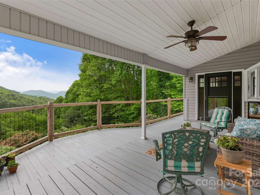 283 Grapevine Cove, Waynesville, NC 28785.  MLS# CAR4260835, YatesRealty ID 14836. Relax outdoors with this covered deck area on main