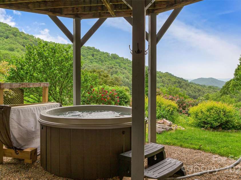 283 Grapevine Cove, Waynesville, NC 28785.  MLS# CAR4260835, YatesRealty ID 14836. The most peaceful setting for a hot tub with garden and mountain views
