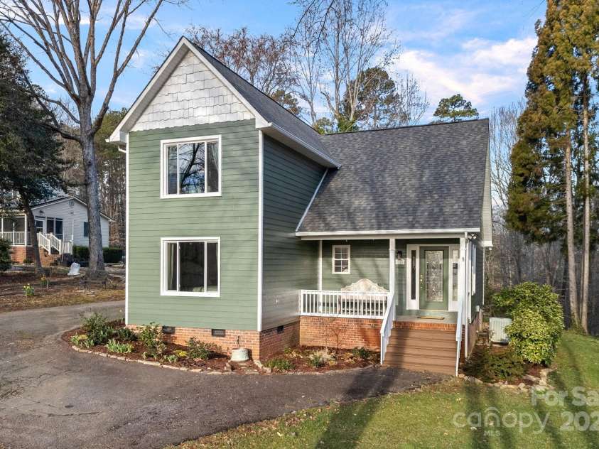 1665 Sherwood Court, Sherrills Ford, NC 28673.  MLS# CAR4223633, YatesRealty ID 14866. Cottage style home & gardens with views of Lake Norman and community lake access!