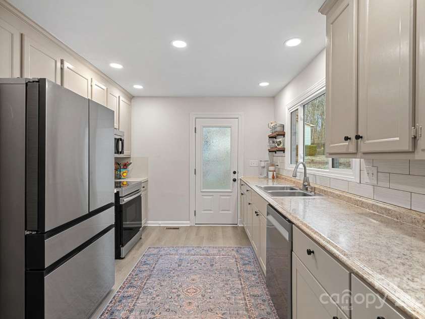 1665 Sherwood Court, Sherrills Ford, NC 28673.  MLS# CAR4223633, YatesRealty ID 14866. Privacy glass door at the side entry, LVP floors and subway tile backsplash