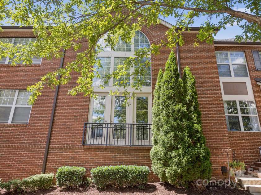 120F Steinbeck Way, Mooresville, NC 28117.  MLS# CAR4258750, YatesRealty ID 14892. Street view of the french doors and big windows facing east.