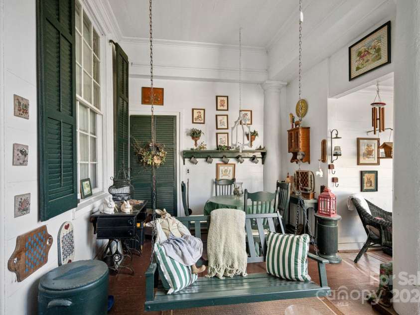 104 Leslie Loop, Mooresville, NC 28115.  MLS# CAR4195674, YatesRealty ID 149. Covered Back Porch with quintessential porch swing!