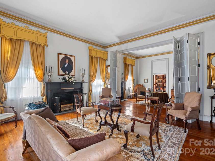 104 Leslie Loop, Mooresville, NC 28115.  MLS# CAR4195674, YatesRealty ID 149. Front Parlor has 3-paneled folding doors that open to the rear Parlor, perfect for entertaining large gatherings