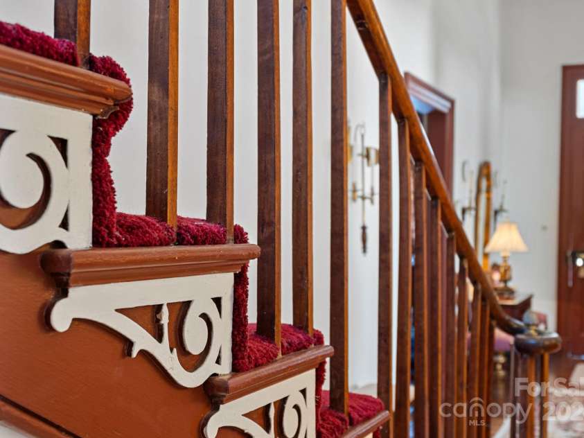 104 Leslie Loop, Mooresville, NC 28115.  MLS# CAR4195674, YatesRealty ID 149. Ornate details on the staircase. Make a note of how it changes as you move up floors!