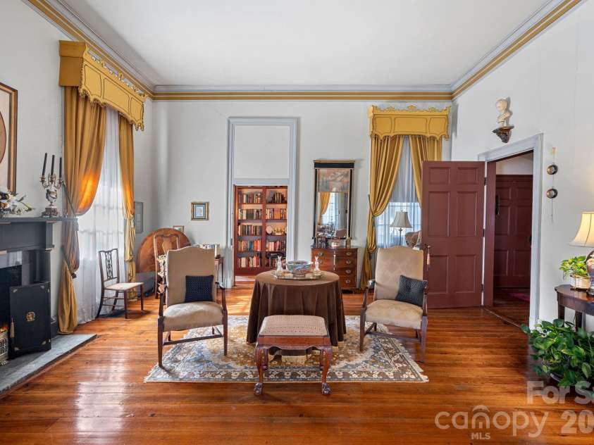 104 Leslie Loop, Mooresville, NC 28115.  MLS# CAR4195674, YatesRealty ID 149. The back parlor sits behind original, wooden folding doors