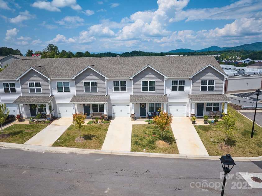 64 Benedict Lane, Weaverville, NC 28787.  MLS# CAR4208936, YatesRealty ID 1490. Drone view of front of building with level access and parking