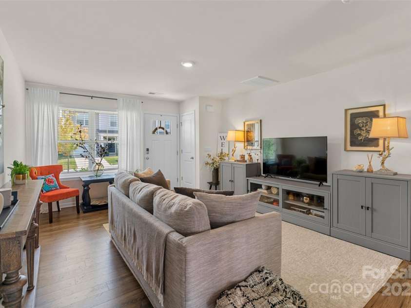 64 Benedict Lane, Weaverville, NC 28787.  MLS# CAR4208936, YatesRealty ID 1490. Light filled living room with low maintenance laminate flooring