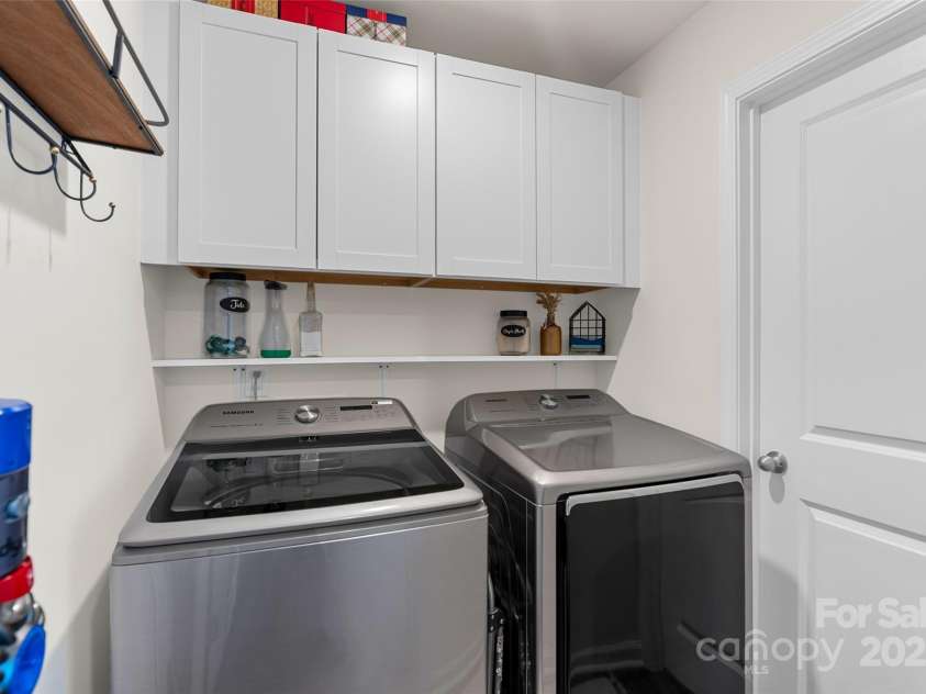 64 Benedict Lane, Weaverville, NC 28787.  MLS# CAR4208936, YatesRealty ID 1490. Main level laundry room with added built in cabinetry/shelving