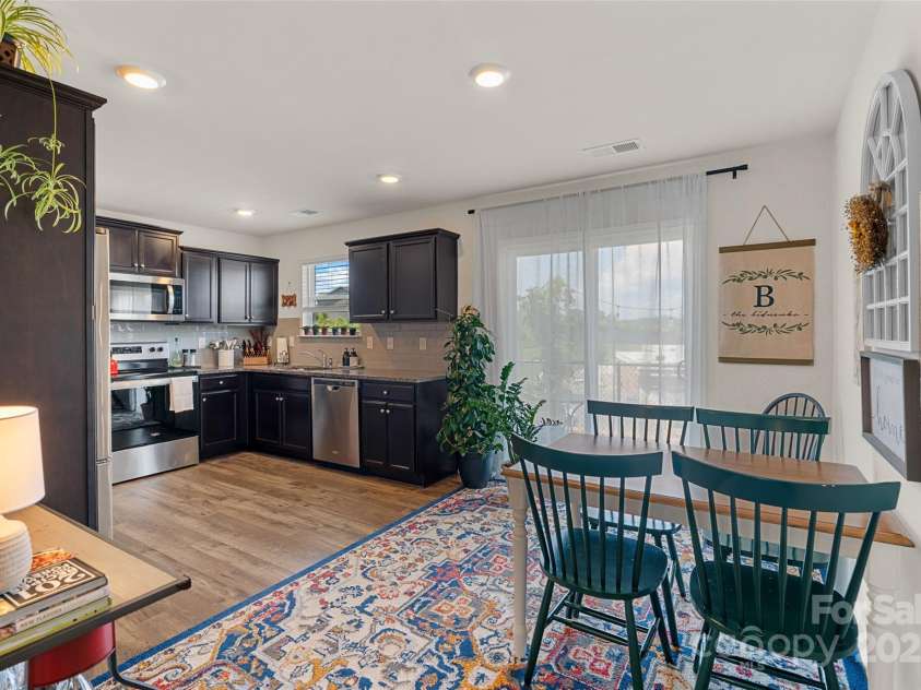 64 Benedict Lane, Weaverville, NC 28787.  MLS# CAR4208936, YatesRealty ID 1490. Open concept kitchen/dining area with sliding door to rear patio