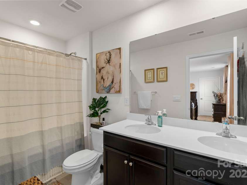 64 Benedict Lane, Weaverville, NC 28787.  MLS# CAR4208936, YatesRealty ID 1490. Primary bath offers double sinks and tub/shower combo