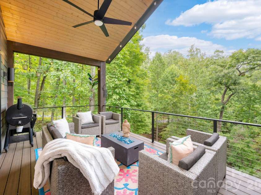 559 Shining Rock Path, Horse Shoe, NC 28742.  MLS# CAR4372540, YatesRealty ID 14910. Covered deck with seating and grilling area, overlooking lush forest.