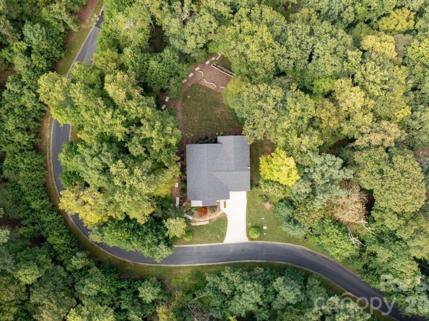 559 Shining Rock Path, Horse Shoe, NC 28742.  MLS# CAR4372540, YatesRealty ID 14910. Set among the trees, with the rolling Blue Ridge Mountains beyond.