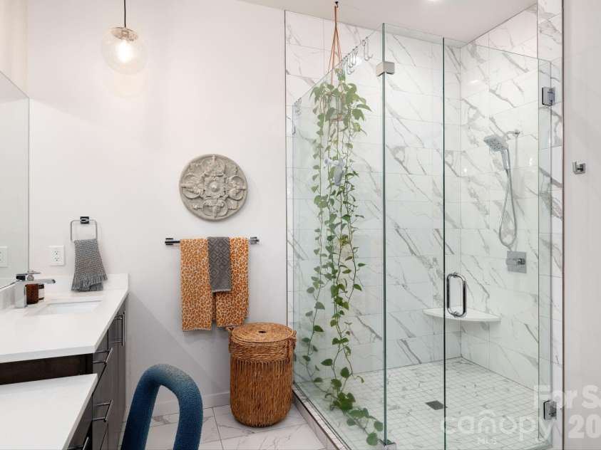 559 Shining Rock Path, Horse Shoe, NC 28742.  MLS# CAR4372540, YatesRealty ID 14910. Spa-like bath with frameless glass shower, elegant tilework, and modern finishes.