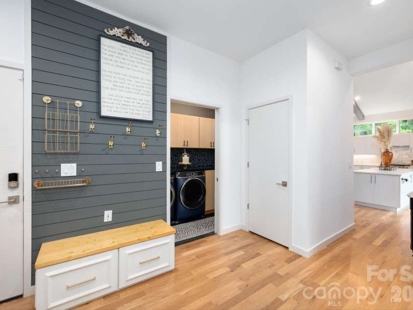 559 Shining Rock Path, Horse Shoe, NC 28742.  MLS# CAR4372540, YatesRealty ID 14910. Stylish mudroom with built-in bench, hooks, and storage.