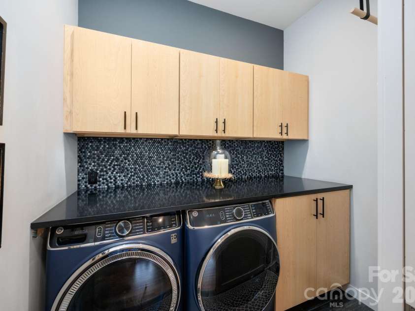 559 Shining Rock Path, Horse Shoe, NC 28742.  MLS# CAR4372540, YatesRealty ID 14910. Well-designed laundry with abundant cabinetry, folding counter.