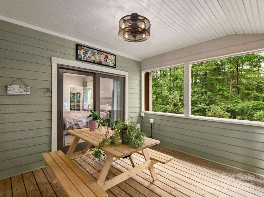 15 Bonnies Lane, Asheville, NC 28803.  MLS# CAR4252426, YatesRealty ID 14917. Access from the primary bedroom onto the screened in porch.