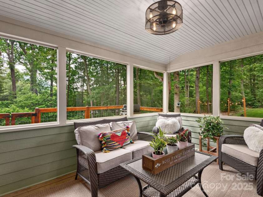 15 Bonnies Lane, Asheville, NC 28803.  MLS# CAR4252426, YatesRealty ID 14917. Fully screened in porch off the living room with direct access from the primary bedroom as well. Faces the back of the house offering the perfect private oasis.