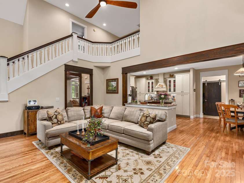 15 Bonnies Lane, Asheville, NC 28803.  MLS# CAR4252426, YatesRealty ID 14917. Massive living room with vaulted ceilings showing just how open the layout is with the kitchen and upper landing.