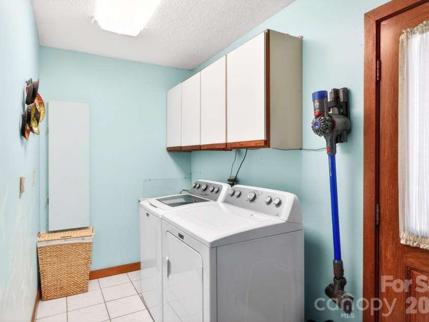 114 Timber Creek Road, Laurel Park, NC 28739.  MLS# CAR4371818, YatesRealty ID 14946. Laundry Room w/ Cabinetry