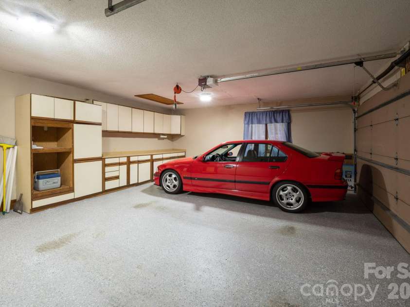 114 Timber Creek Road, Laurel Park, NC 28739.  MLS# CAR4371818, YatesRealty ID 14946. Main Level Garage w/ Epoxy Floors