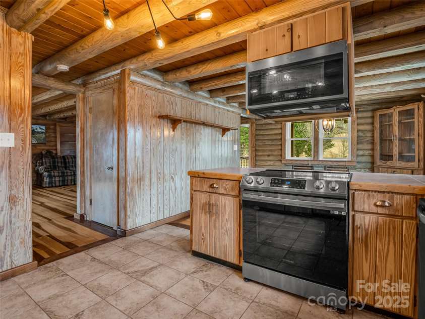 2069 Pot Shoals Road, Saluda, NC 28773.  MLS# CAR4216545, YatesRealty ID 14946. Kitchen Open To Dining Room