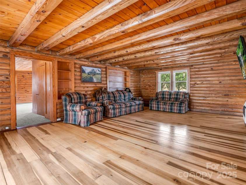 2069 Pot Shoals Road, Saluda, NC 28773.  MLS# CAR4216545, YatesRealty ID 14946. Living Room With View Of Primary Bedroom