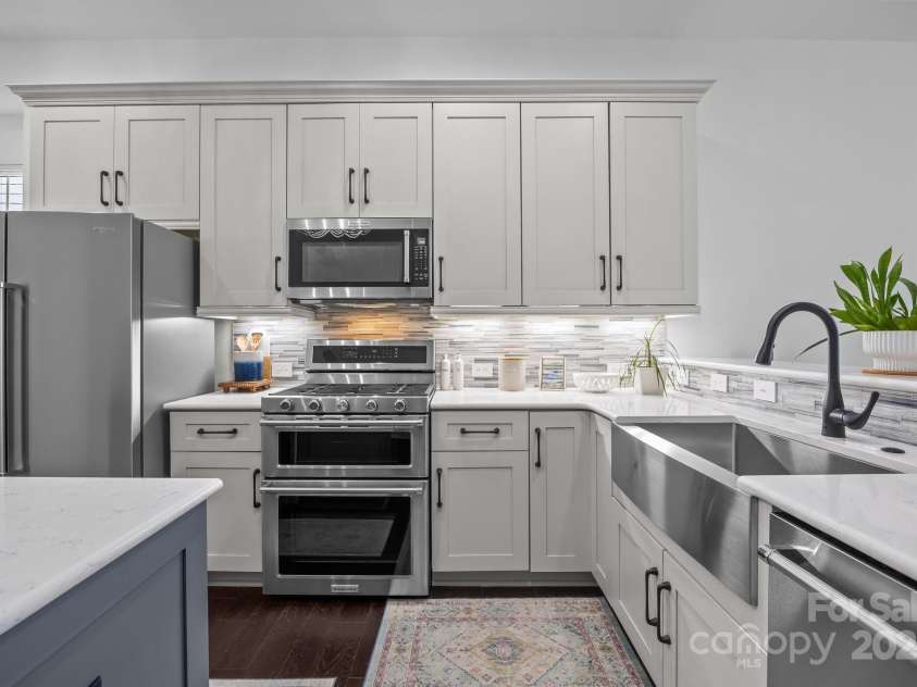 15913 Trenton Place Road, Huntersville, NC 28078.  MLS# CAR4259795, YatesRealty ID 14953. KitchenAid double oven gas range, microwave, and dishwasher
