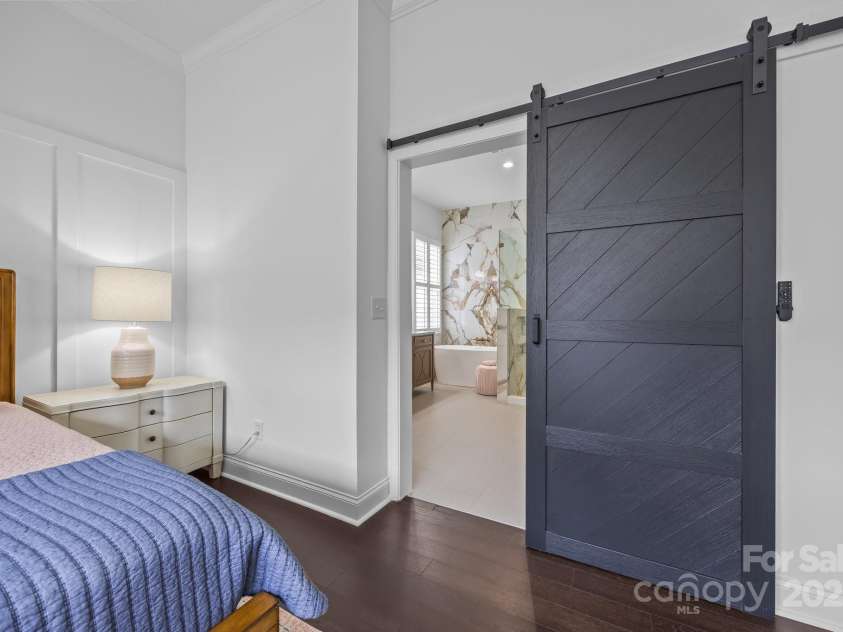15913 Trenton Place Road, Huntersville, NC 28078.  MLS# CAR4259795, YatesRealty ID 14953. Modern barn door leads to the remodeled primary bathroom