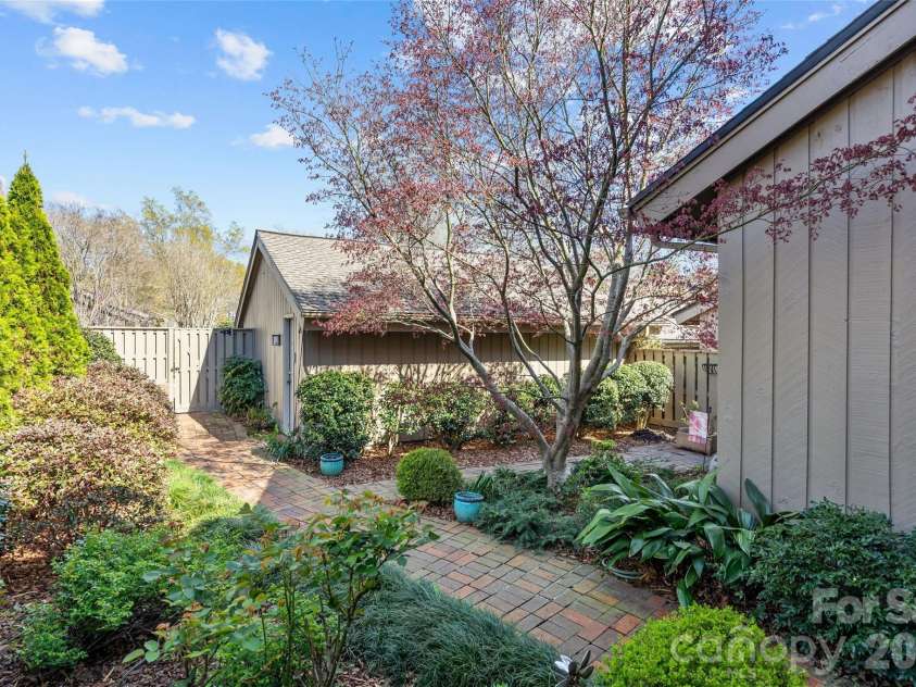 5120 Dunes Court, Charlotte, NC 28226.  MLS# CAR4367666, YatesRealty ID 14955. Lush landscaping with flowering shrubs & rosebushes