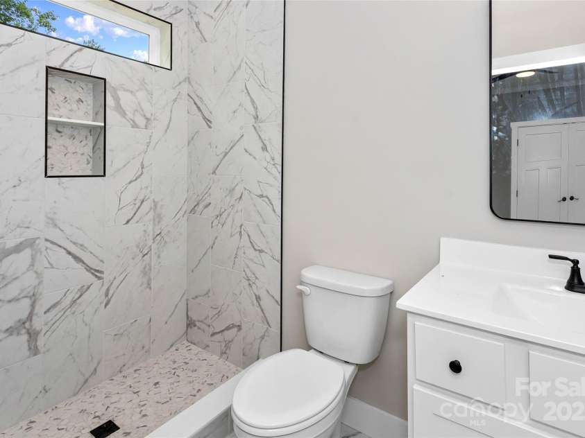 114 Orchard Street, Old Fort, NC 28762.  MLS# CAR4314228, YatesRealty ID 14980. En suite primary bath with beautiful tile work and huge shower. 