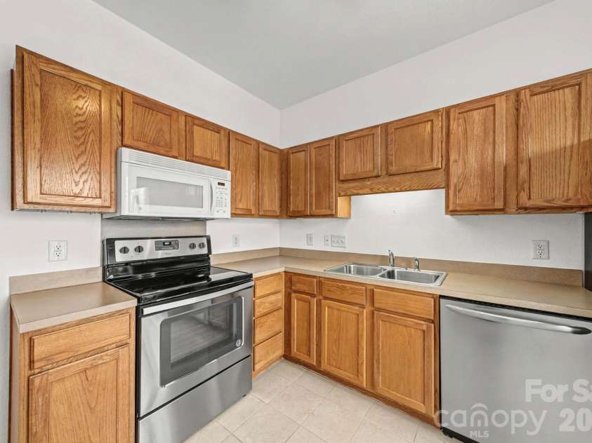 6216 Lentz Way, Harrisburg, NC 28075.  MLS# CAR4341681, YatesRealty ID 14988. Kitchen with oven/microwave & dishwasher