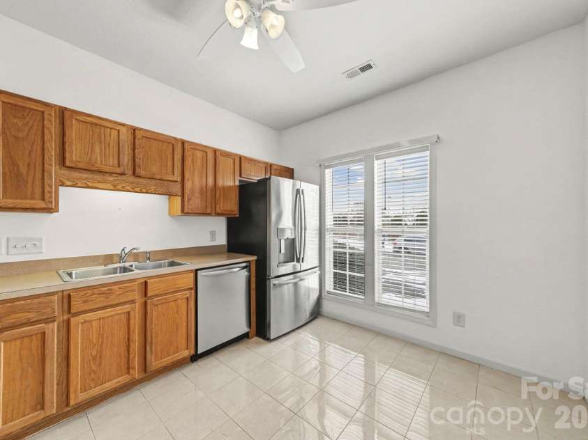 6216 Lentz Way, Harrisburg, NC 28075.  MLS# CAR4341681, YatesRealty ID 14988. Kitchen with Refrigerator that stays & bright windows