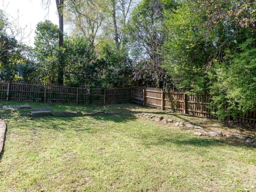 224 4th Avenue, Gastonia, NC 28052.  MLS# CAR4362798, YatesRealty ID 14989. Nice back yard w/ pebble and stone walkway