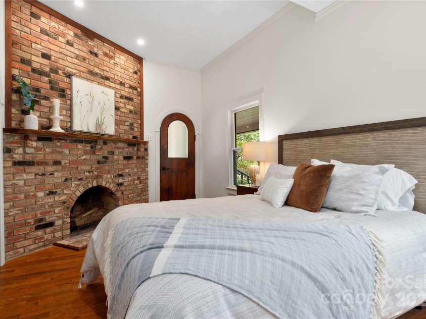 528 Padgettown Road, Black Mountain, NC 28711.  MLS# CAR4261507, YatesRealty ID 1499. Primary Suite- Brick fireplace 