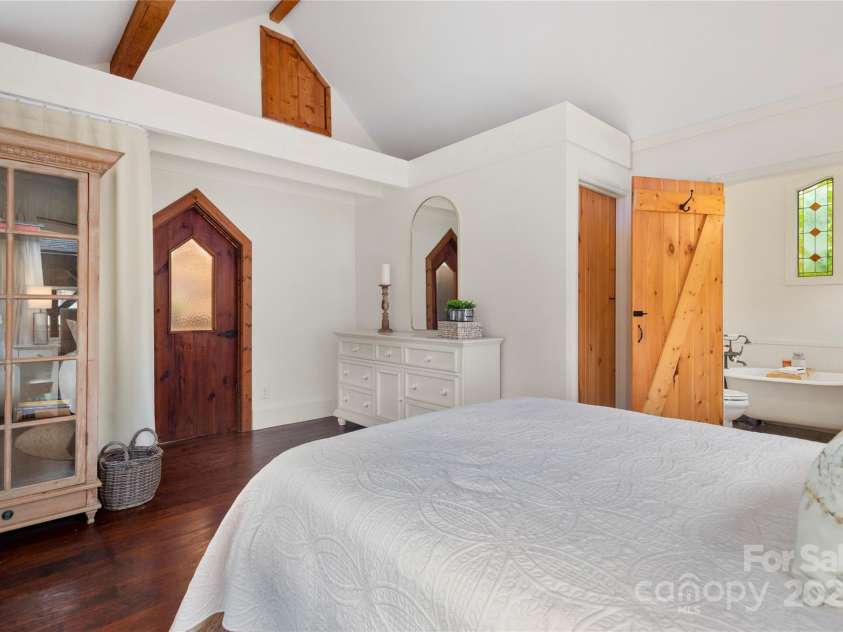528 Padgettown Road, Black Mountain, NC 28711.  MLS# CAR4261507, YatesRealty ID 1499. Secondary Bedroom with custom wood doors, wood flooring and storage loft. 