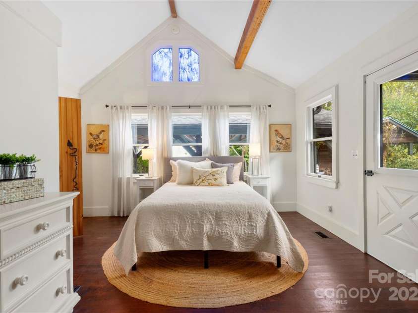528 Padgettown Road, Black Mountain, NC 28711.  MLS# CAR4261507, YatesRealty ID 1499. Secondary Bedroom with vaulted ceiling and stained glass window.