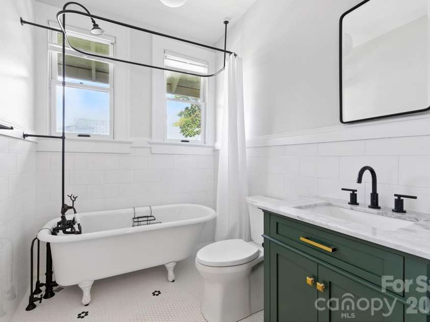 38 Austin Avenue, Asheville, NC 28801.  MLS# CAR4364938, YatesRealty ID 14994. Fully remodeled main bath w/ refinished original tub, stylish new fixtures, and marble countertops