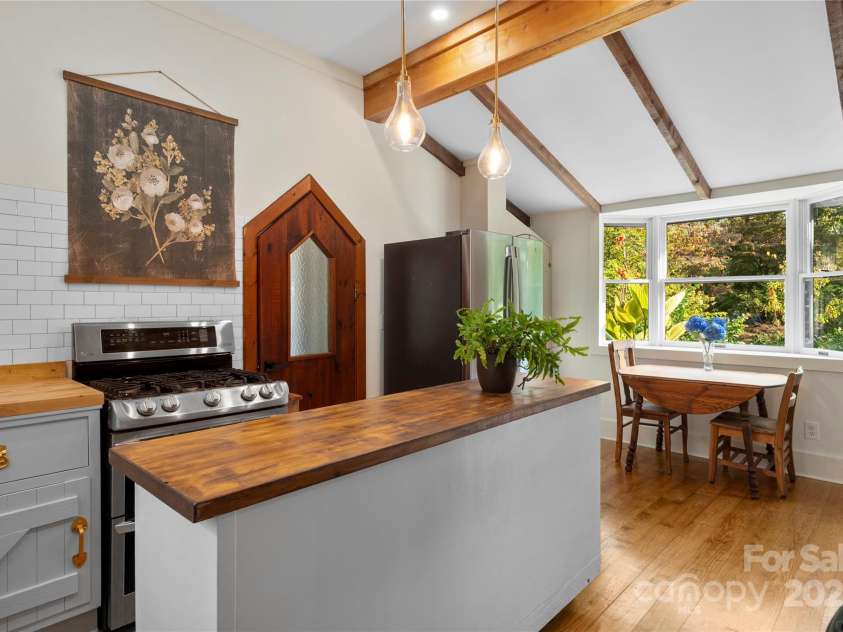 528 Padgettown Road, Black Mountain, NC 28711.  MLS# CAR4261507, YatesRealty ID 14998. Custom wood door, open beamed ceiling, custom moveable island. 