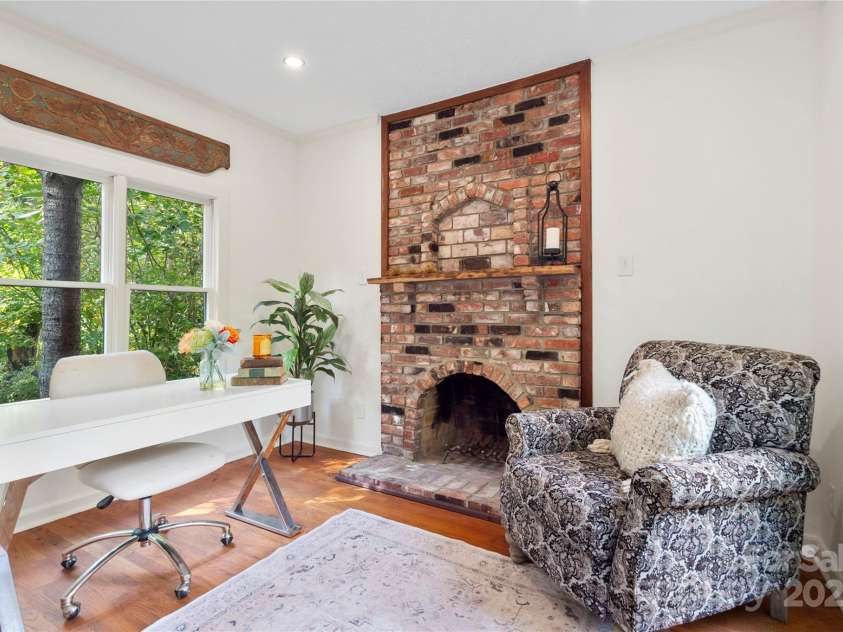 528 Padgettown Road, Black Mountain, NC 28711.  MLS# CAR4261507, YatesRealty ID 14998. Primary Suite den with brick fireplace. 