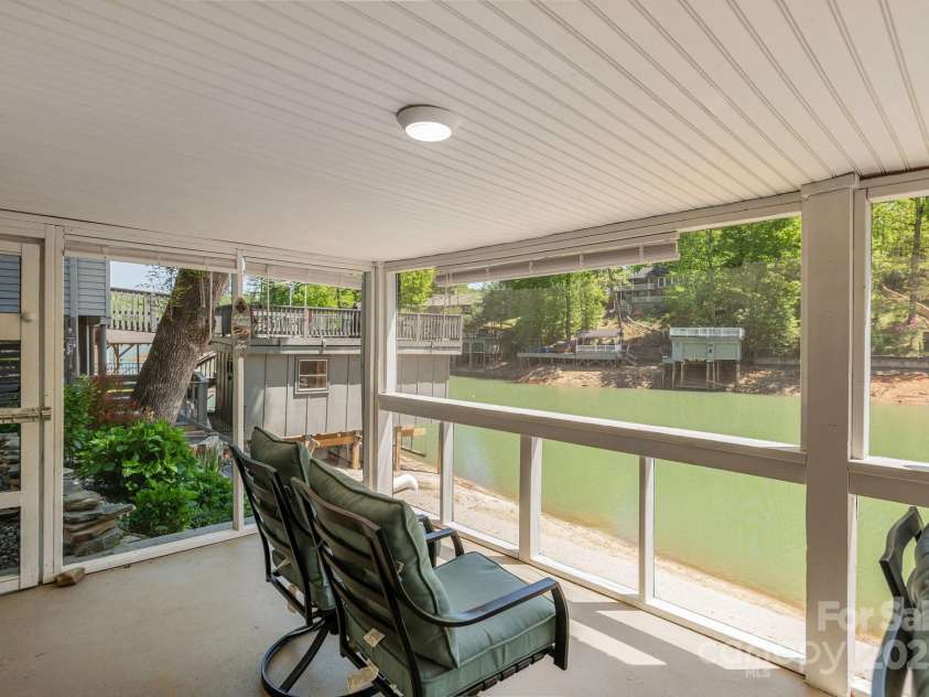 386 Charlotte Drive, Lake Lure, NC 28746.  MLS# CAR4243740, YatesRealty ID 15020. Lower Level: Screened porch overlooking the cove