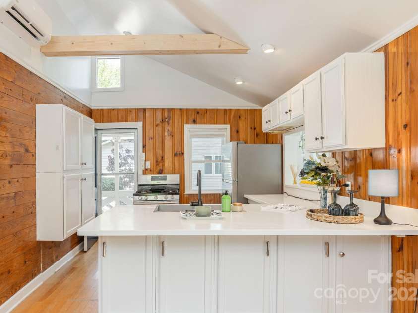 386 Charlotte Drive, Lake Lure, NC 28746.  MLS# CAR4243740, YatesRealty ID 15020. Main Level: Kitchen. Honey, where are the barstools?