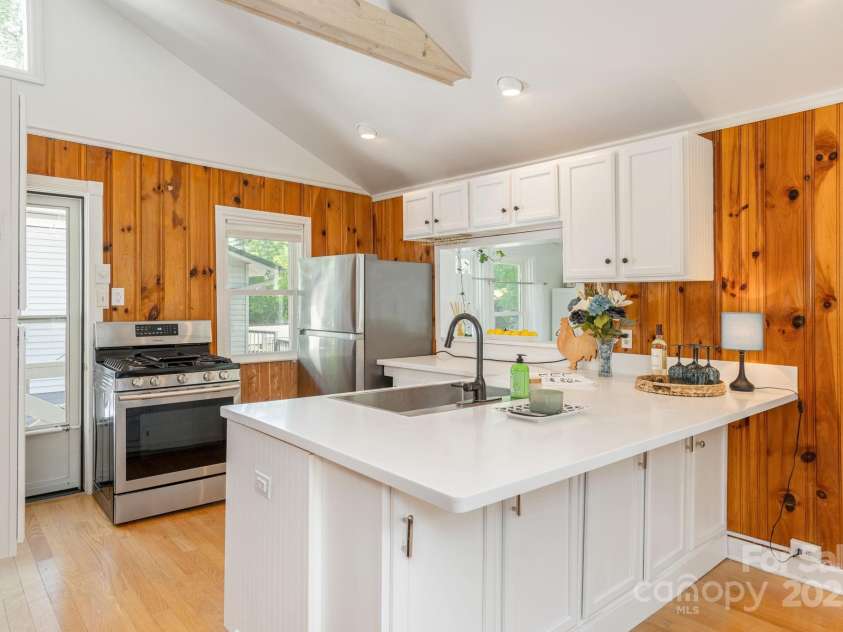 386 Charlotte Drive, Lake Lure, NC 28746.  MLS# CAR4243740, YatesRealty ID 15020. Main Level: Kitchen with passthrough to the sunroom