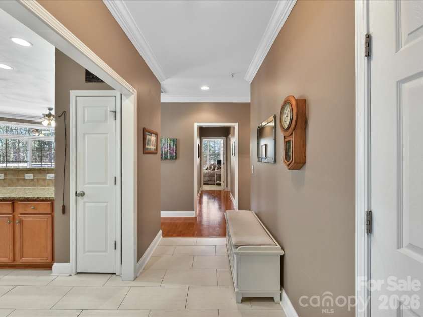 8665 Edinburgh Square Drive, Cornelius, NC 28031.  MLS# CAR4357240, YatesRealty ID 15038. Bright and welcoming entryway featuring tile flooring, crown molding, and an open flow into the kitchen and main living areas.